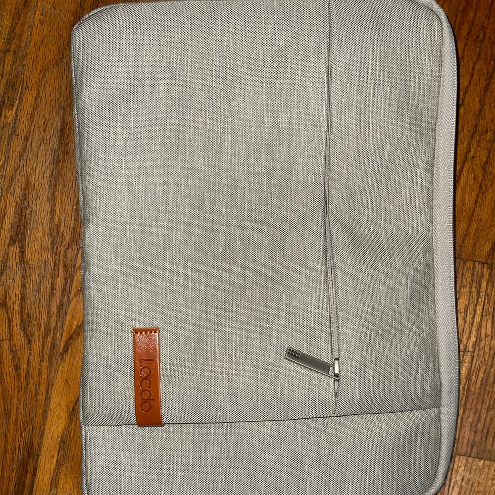 Never before used gray laptop case, 12.5 inches by 9 inches.